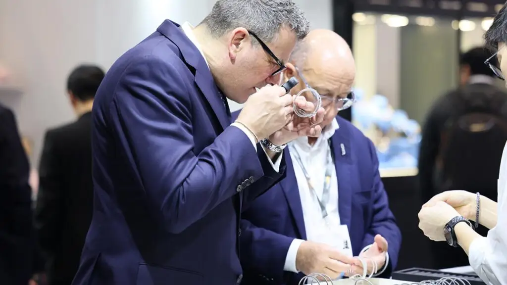Participants at the Hong Kong International Jewellery Show inspecting jewelry image