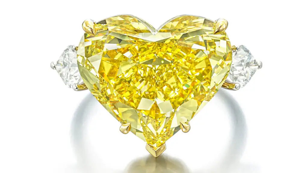 Fancy-vivid-yellow diamond center stone and two pear-shaped diamond side stones ring at Sotheby's image