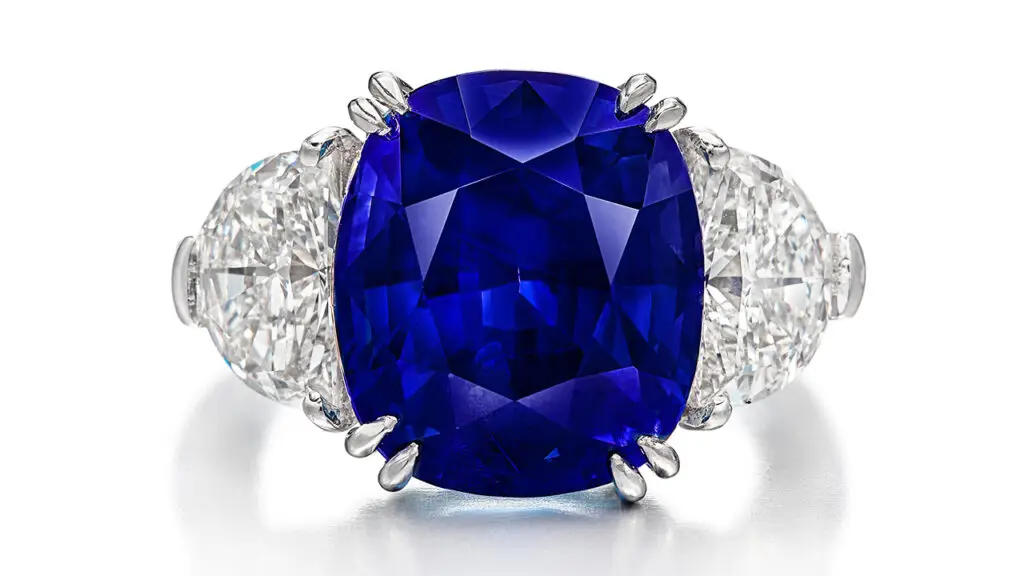 Cushion-shaped Kashmir sapphire set between two half-moon-shaped diamonds ring image