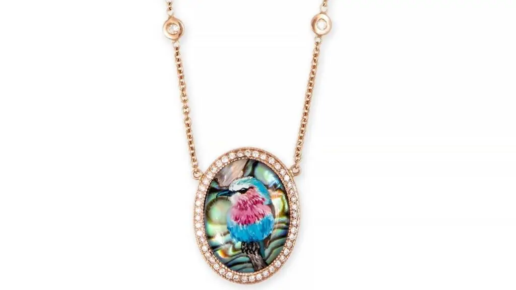An abalone pendant by Jacquie Aiche with a miniature portrait of a bird image