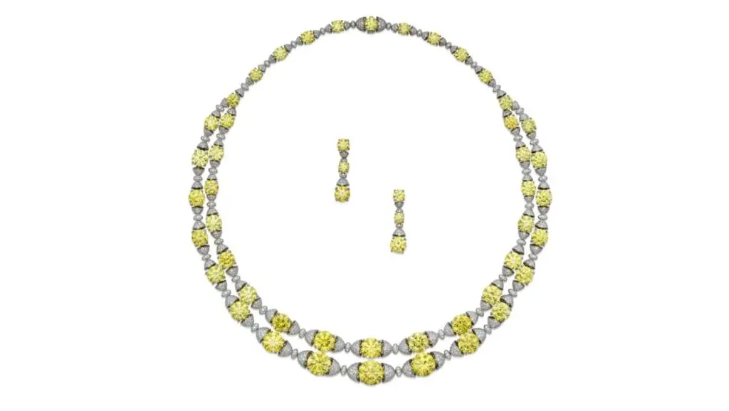 Necklace and earrings set, featuring 50 graduated round, fancy-vivid-yellow diamonds and one round, fancy-intense-yellow diamond weighing a total of 55.26 carats, accented by white diamonds image.
