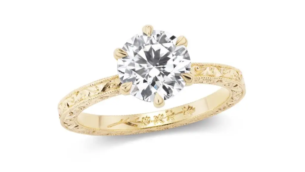 A diamond ring from Fewer Finer with a carved gold band image