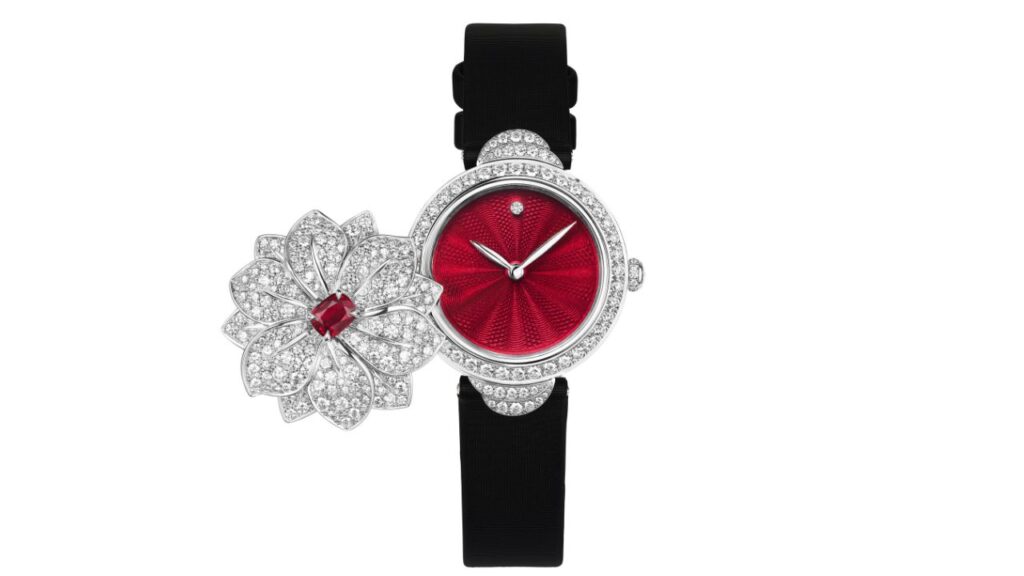 A white-gold and diamond secret watch from Chaumet's Jewels by Nature collection with a cushion-cut, 0.74-carat ruby and a red dial image