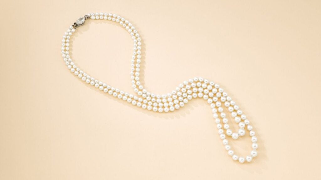 A necklace with 209 natural saltwater pearls in two graduating rows. Its clasp bears an old marquise-cut, 2.17-carat, L-color, SI-clarity diamond between old brilliant-cut diamond terminals at Sotheby's image