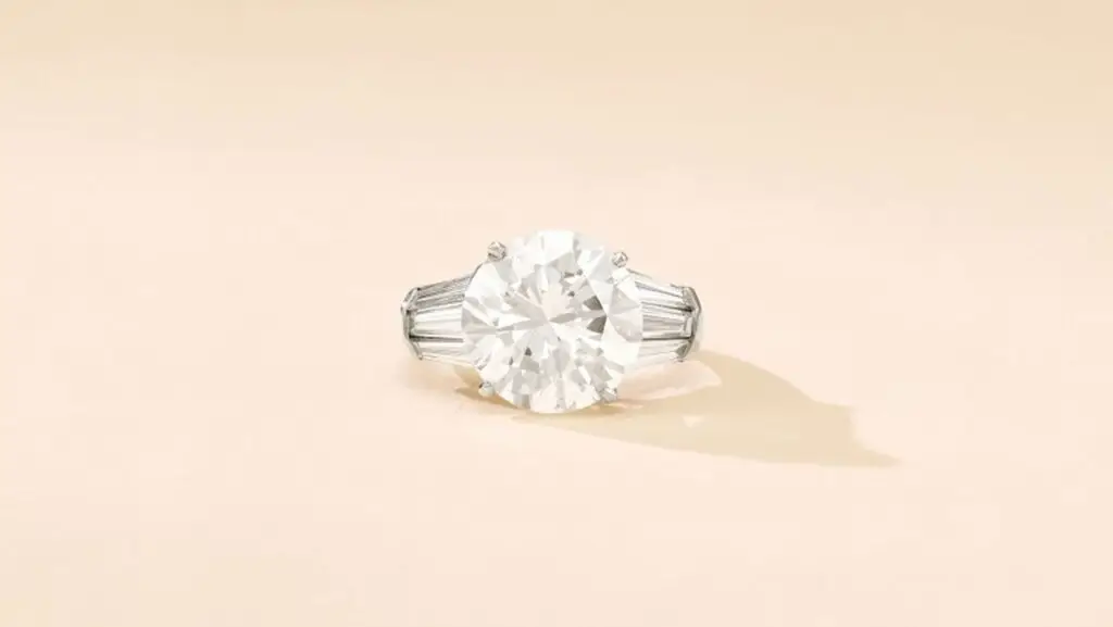 A ring with a brilliant-cut, 8.03-carat, G-color, VS2-clarity diamond and curved baguette shoulders at Sotheby's image