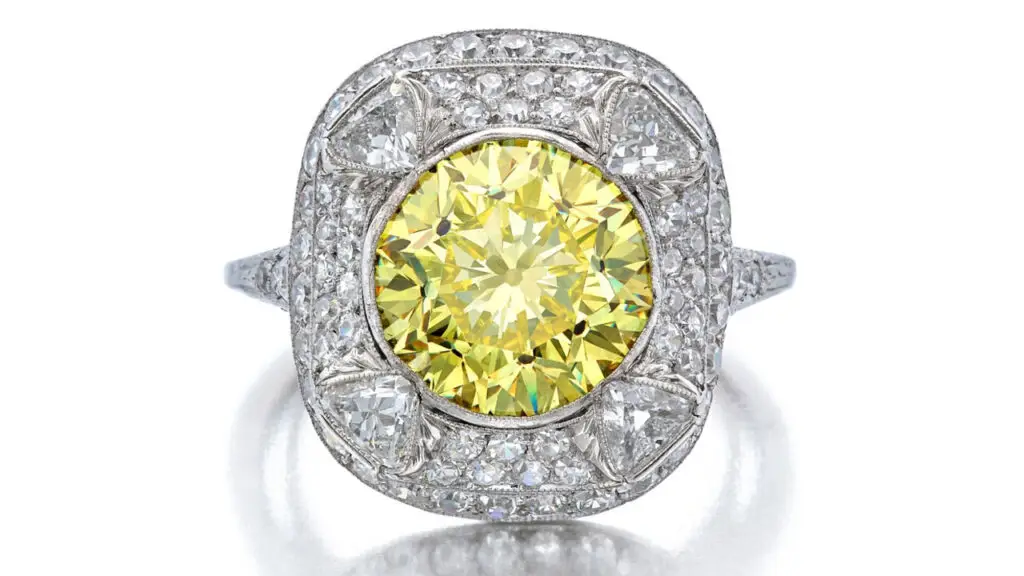 Round fancy-vivid-yellow diamond center stone, surrounded by triangle-shaped, and old European and single-cut diamonds ring at Sotheby's image