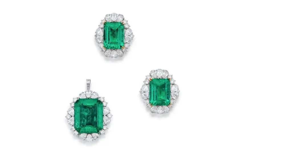 A pair of earrings and a pendant featuring three emerald-cut emeralds, each surrounded by pear- and round-shaped diamonds at Sotheby's image