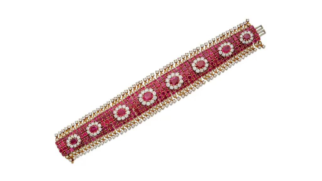 Harry Winston bracelet set with round rubies and bordered by round diamonds at Sotheby's image