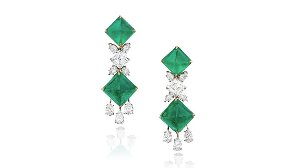 Pair of Graff earrings bearing four sugarloaf cabochon Colombian emeralds spaced by two square emerald-cut diamonds, and 14 pear-shaped accent diamonds at Sotheby's image