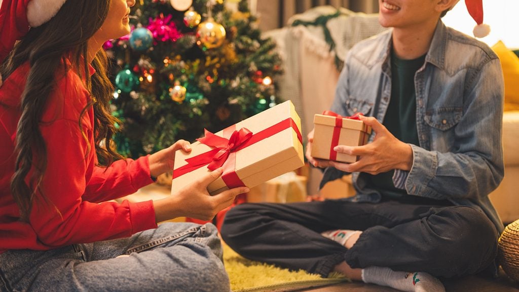 A couple exchanging holiday gifts image