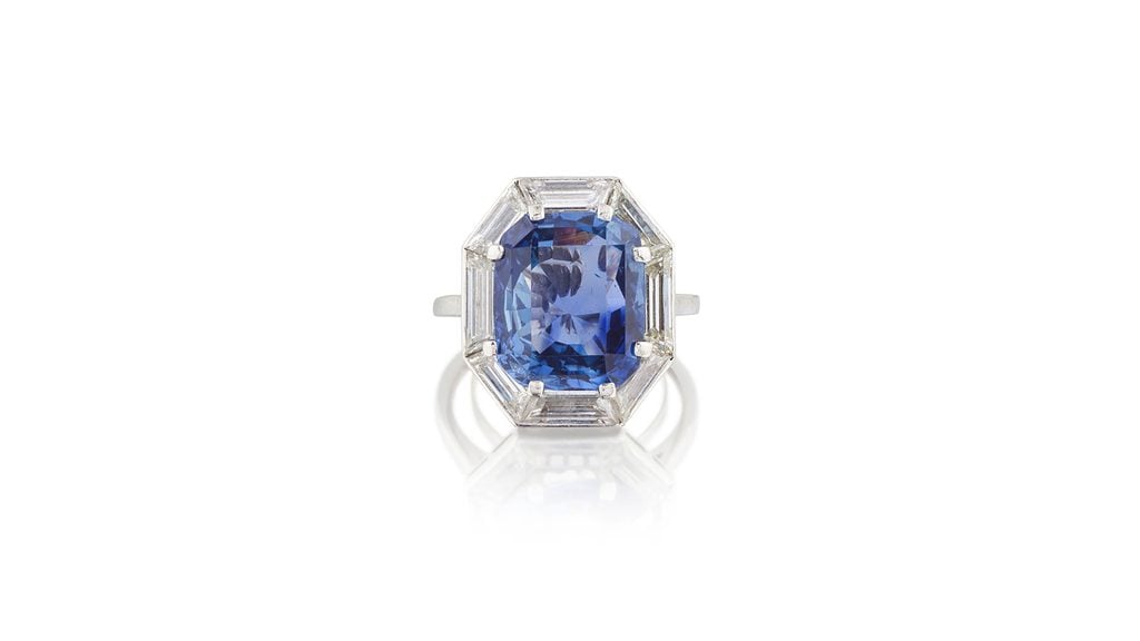 A Chaumet ring centering a step-cut, 13.70-carat Sri Lankan sapphire within a surround of eight step-cut diamonds at Bonhams image