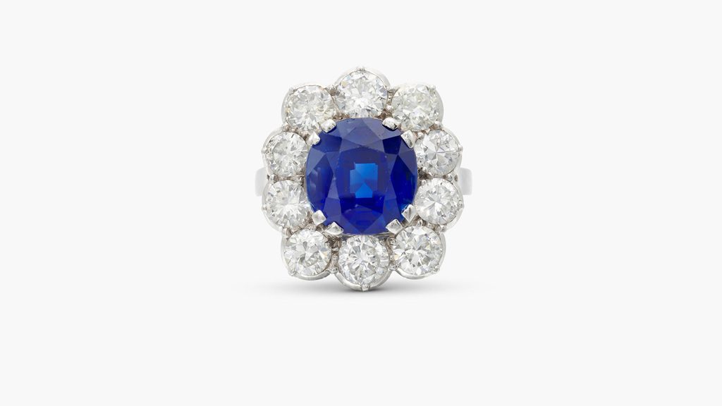 A ring centering a cushion-shaped, 6.40-carat Kashmir sapphire in a diamond surround at Sotheby's image