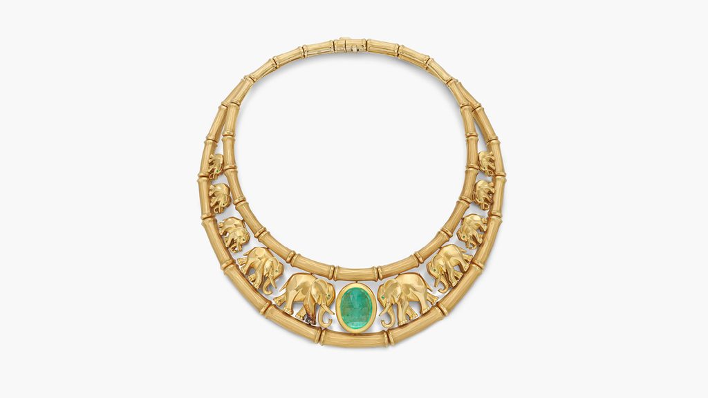This Cartier necklace sports an emerald cabochon at the center, with graduated marching elephants, each containing a circular-cut emerald eye at Sotheby's image