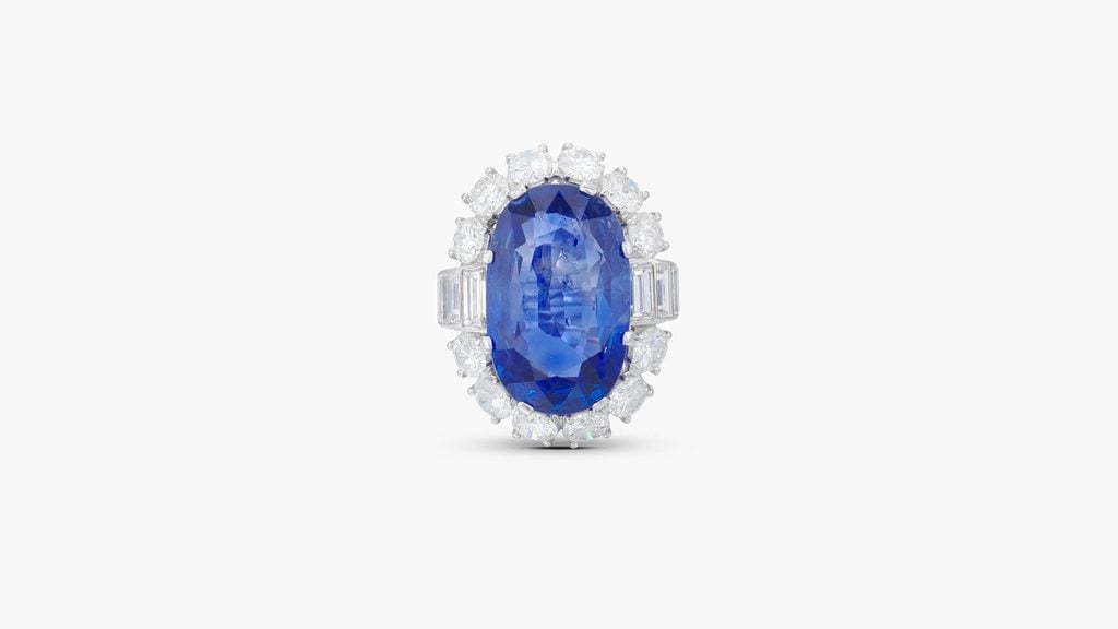 A ring starring an oval-shaped,15.08-carat Burmese sapphire in a brilliant-cut diamond surround at Sotheby's image