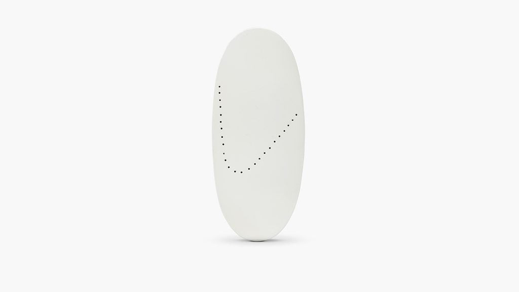This cuff from Lucio Fontana features a white lacquered oval with pierced holes attached to a silver bracelet at Sotheby's image