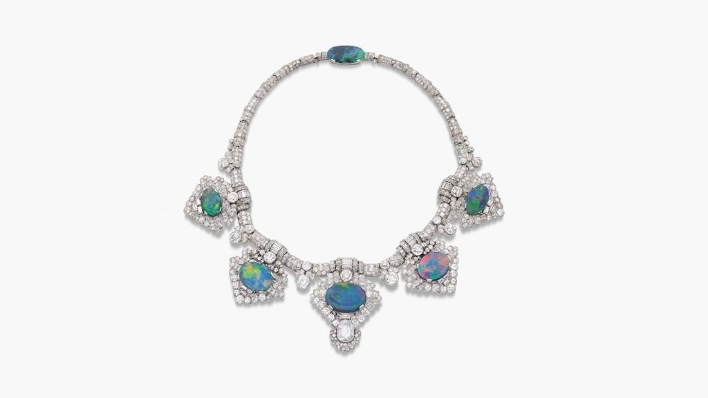 This necklace, formerly in the collection of Mary Cavendish, Duchess of Devonshire, is from Cartier. It has five detachable brooches, each centering an oval black opal, with old mine-, old European- and single-cut diamonds throughout, accented with baguette diamonds. There is also a fitting that allows the piece to be worn as a tiara at Sotheby's image