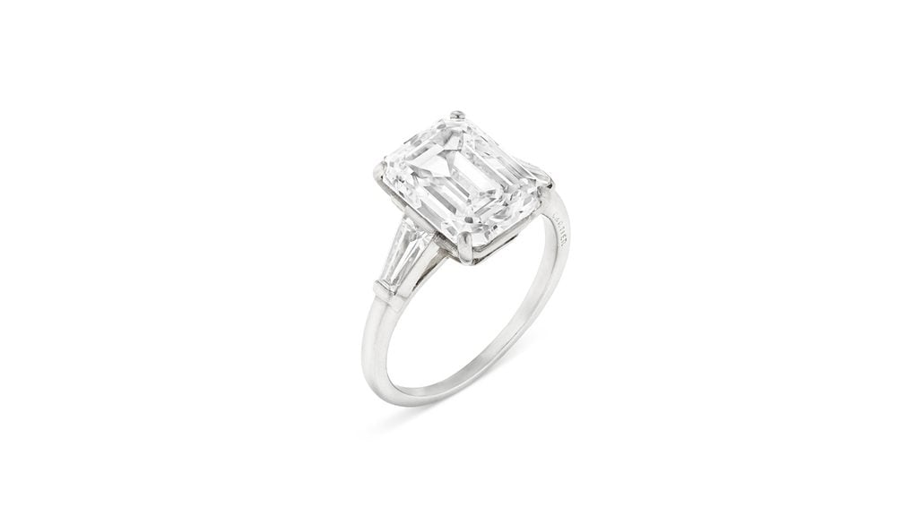 A Cartier ring circa 1950 bears an emerald-cut, 5-carat, D, VS1 diamond with tapered baguette-cut diamonds at Christie's image