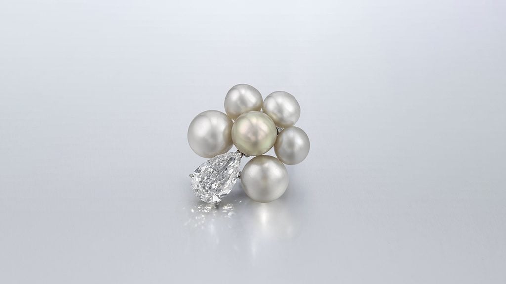 A brooch with a cluster of natural pearls suspending a pear-shaped diamond at Christie's image