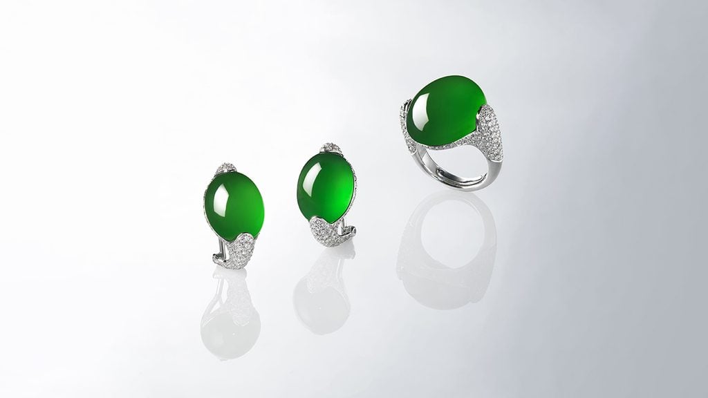 A set that includes a ring and earrings featuring jadeite center stones and diamonds at Christie's image
